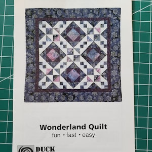 May include: A quilting pattern for a "Wonderland Quilt" with a colourful geometric design. The pattern is from Duck Soup and is described as "fun, fast, and easy".