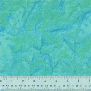 Op de afbeelding: Een close-up van een stof met een aquareleffect. De stof heeft een mix van teal, turquoise en lichtgroene tinten, waardoor een gemarmerd of gestructureerd uiterlijk ontstaat. Een liniaal staat onderaan, met metingen in centimeters.