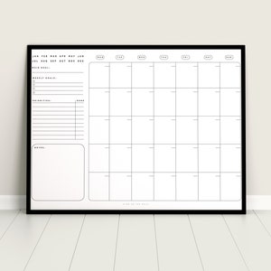 May include: A black and white monthly calendar planner with a black frame. The calendar has sections for weekly goals, priorities, and notes. The calendar is labeled with the months of the year and days of the week.