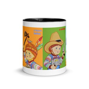 May include: White ceramic mug with a black rim. The mug features a colorful illustration of three children dressed as a brave Indian, a cowboy, and a soldier. The text "a brave Indian" and "a cowboy" are visible on the mug.