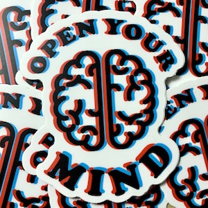 May include: A white sticker with a black and blue brain graphic and the text "OPEN YOUR MIND" in red and blue letters.