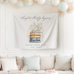 May include: A white banner with the text "Chapter thirty begins" and a watercolor illustration of a stack of books with flowers. The text "Jessie's Book Club Est. 1995" is below the illustration.