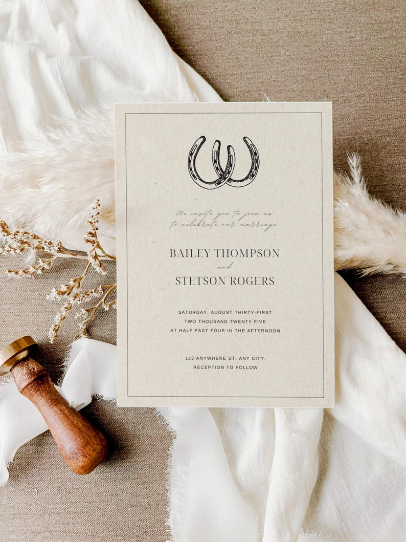 May include: A rustic wedding invitation with a brown background and a black and white illustration of two horseshoes. The text reads "We invite you to join us to celebrate our marriage Bailey Thompson and Stetson Rogers Saturday, August Thirty-First Two Thousand Twenty Five at Half Past Four in the Afternoon 123 Anywhere St. Any City. Reception to Follow"