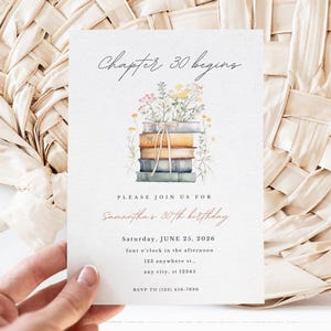 May include: A white invitation card with a watercolor illustration of a stack of books with flowers on top. The text on the card reads "Chapter 30 begins" and "Samantha's 30th birthday".
