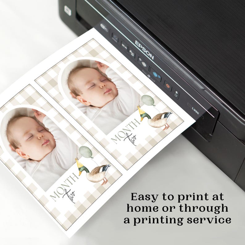 May include: Two printable cards with a gingham background and a photo frame. The cards feature a baby sleeping and a duck with balloons. The text on the cards reads "Month Two".