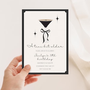 May include: Black and white birthday invitation with a martini glass illustration and the text "A tiny bit older. Please join us to celebrate Jaclyn's 30th birthday. November 21st at 8:00 PM. 123 Anywhere Street, Any City. RSVP to 1023456-7890."
