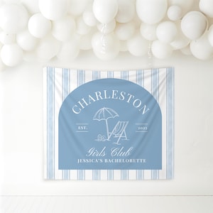 May include: A blue and white striped backdrop with a blue circle containing the text "Charleston Girls Club Jessica's Bachelorette" with a beach chair and umbrella graphic.