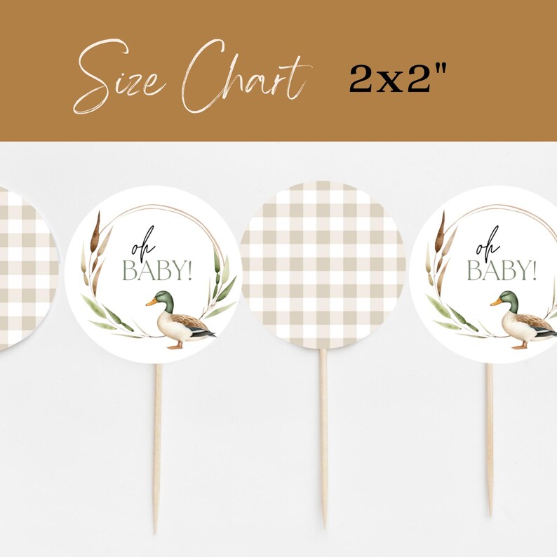May include: Four 2x2 inch round cupcake toppers. Two toppers feature a brown and white gingham pattern. Two toppers feature a watercolor illustration of a duck with green and brown feathers, surrounded by green leaves and brown reeds. The text "oh baby!" is written in black on the toppers with the duck illustration.