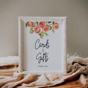 May include: White framed sign with a watercolor peach design and the text "Cards & Gifts Thank You!"