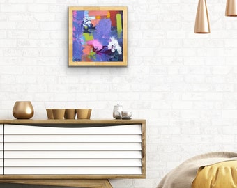May include: Abstract painting with a wooden frame. The painting features a variety of colors, including purple, pink, yellow, and green. The colors are applied in a thick, textured style.