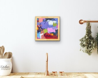May include: Abstract painting in a wooden frame with a colorful design of purple, pink, blue, green, red, and white paint strokes.