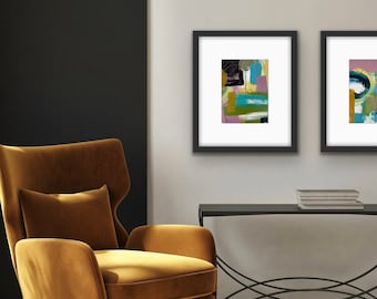 May include: A mustard yellow velvet armchair with a matching ottoman and a white throw blanket. Two framed abstract paintings hang on the wall behind the chair.