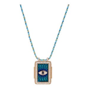 May include: A gold necklace with a blue and green enamel pendant featuring a stylised eye with a single sapphire stone. The necklace is made with a braided blue and gold cord.