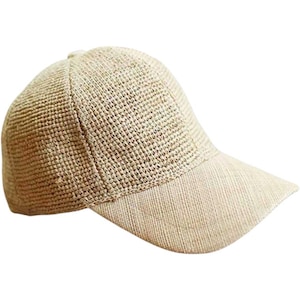 May include: A beige woven straw baseball cap with a solid beige brim.