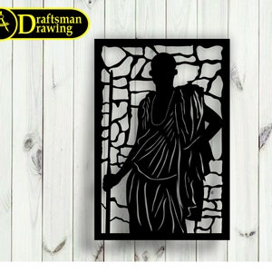 May include: Black metal wall art featuring a silhouette of a person standing in front of a stone wall. The person is wearing a long robe and has a necklace. The art is cut out in a detailed design.