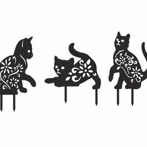 May include: Three black metal cat garden stakes in different poses. Each cat has a floral design cut out of its body. The stakes are designed to be placed in the ground for outdoor decoration.