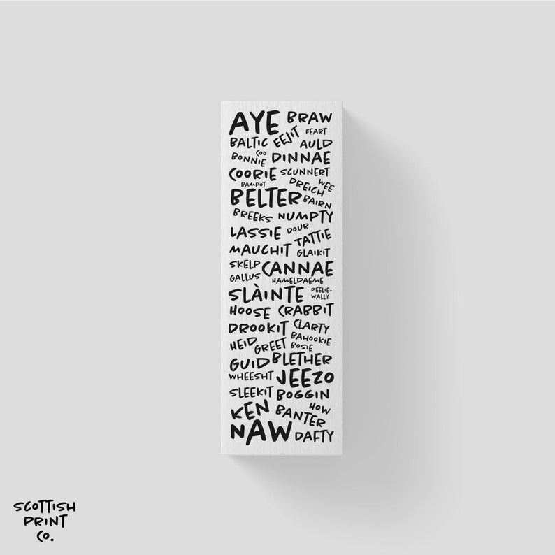 May include: A black and white word art print with Scottish slang words and phrases. The words are arranged in a vertical column, with the word "Aye" at the top and "Naw" at the bottom.