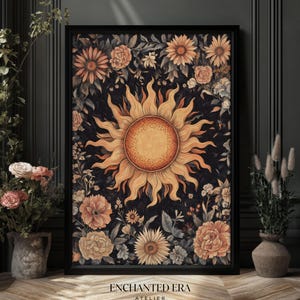 May include: A digital art print featuring a stylized sun with a yellow center and orange rays surrounded by a dark background with floral designs in shades of orange, yellow, and white. The print has the text "ENCHANTED ERA ATELIER" at the bottom.