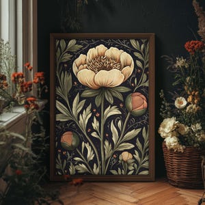 May include: A framed art print featuring a stylized illustration of a white peony flower with pink accents, surrounded by green leaves on a dark blue background.