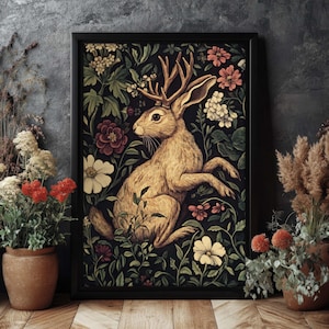 May include: A vintage-style illustration of a brown rabbit with antlers, surrounded by a lush floral pattern in shades of pink, white, and green. The rabbit is sitting on its hind legs, with its front paws raised.