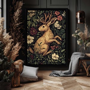 May include: A vintage-style illustration of a brown rabbit with antlers, surrounded by colorful flowers and foliage. The artwork is framed and displayed on a dark wall.