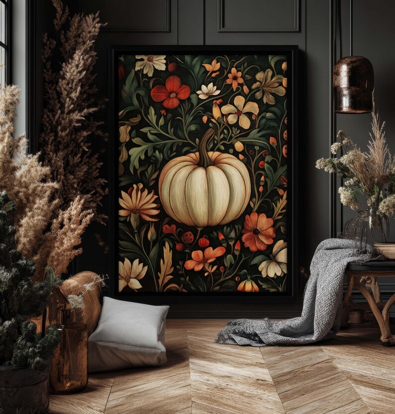 Peut inclure: Une impression d'art encadr&eacute;e repr&eacute;sentant une citrouille cr&egrave;me entour&eacute;e de fleurs orange, blanches et jaunes et de feuillage vert sur un fond sombre. L'&oelig;uvre, dans un cadre noir, est id&eacute;ale pour la d&eacute;coration d'automne.