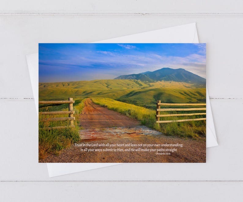 May include: A greeting card featuring a scenic landscape with a dirt road, wooden fence, and a mountain in the background. The card includes the text "Trust in the Lord with all your heart..." from Proverbs 3:5-6.