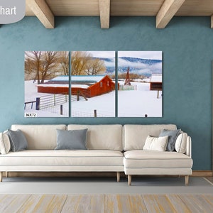 May include: A three-panel canvas print of a red barn in a snowy landscape. The barn has a white roof and is surrounded by trees and a fence. The print is 36 inches wide by 72 inches tall.