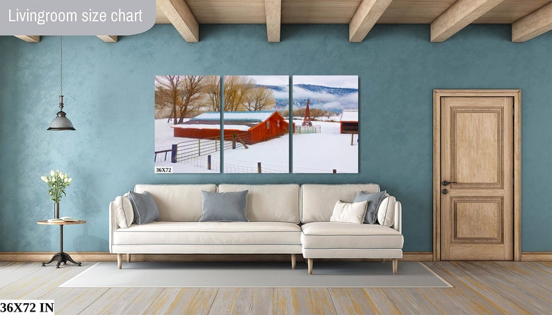 May include: A three-panel canvas print of a red barn in a snowy landscape. The barn has a white roof and is surrounded by trees and a fence. The print is 36 inches wide by 72 inches tall.
