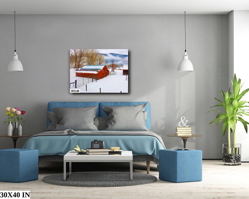 May include: A red barn with a white roof sits in a snowy field. The barn is surrounded by trees and a fence. The image is a 30x40 inch print.