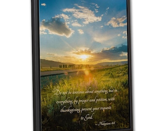May include: A rectangular framed wall art piece featuring a sunset landscape over a grassy field and a road. The image includes the text: Do not be anxious about anything, but in everything, by prayer and petition, with thanksgiving, present your requests to God. Philippians 4:6.