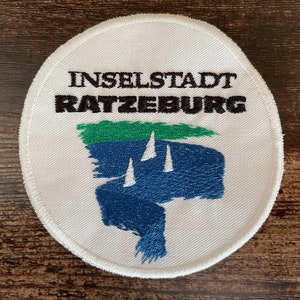 May include: A set of three ceramic mugs with a speckled, matte finish. The mugs are in shades of cream, light gray, and dark gray. Each mug has a simple, minimalist design, perfect for coffee or tea.