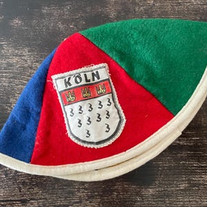 May include: A set of three ceramic mugs with a speckled, matte finish. The mugs are in shades of cream, light gray, and dark gray. Each mug has a simple, minimalist design, perfect for coffee or tea.