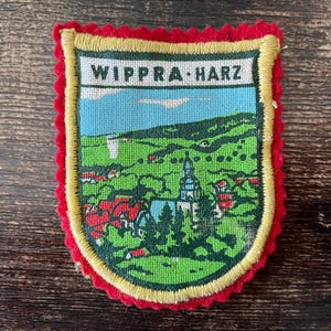 May include: A rustic wooden sign with the text "Welcome to our home" in white lettering. The sign features a distressed finish and a simple, inviting design, perfect for front door decor.