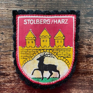 May include: A set of three ceramic vases in varying heights and shapes. The vases are glazed in a matte white finish, offering a minimalist aesthetic. The tallest vase is approximately 10 inches high.