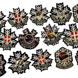 May include: A collection of embroidered ski resort patches, featuring names like "Praz de Lys" and "Valberg 1700m." Each patch has a black snowflake design with white detailing and colourful emblems. Ideal for jackets or bags, these patches are a great souvenir.