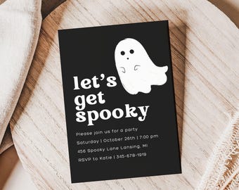 May include: A rectangular black party invitation card featuring a white cartoon ghost and the text "let's get spooky". The card includes event details: Saturday, October 26th, 7:00 pm, 456 Spooky Lane Lansing, MI, and RSVP to Katie at 345-678-1919.