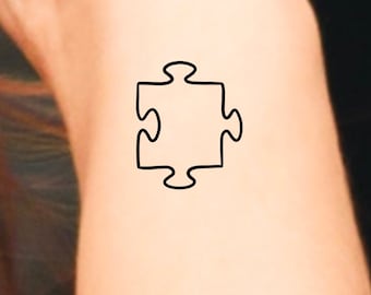 autism puzzle piece tattoo on arm