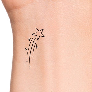 This temporary tattoo is a shooting star outline with a trail of sparkles.