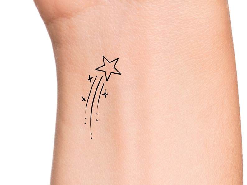 This temporary tattoo is a shooting star outline with a trail of sparkles.