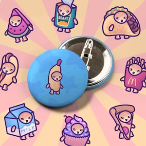 May include: A set of 10 colorful pinback buttons featuring cartoon cats dressed up as different foods. The buttons include a cat dressed as a watermelon, a hot dog, a banana, a carton of milk, a cupcake, a pizza, a french fry, a taco, a can of beans, and a pinback button with a blank surface.