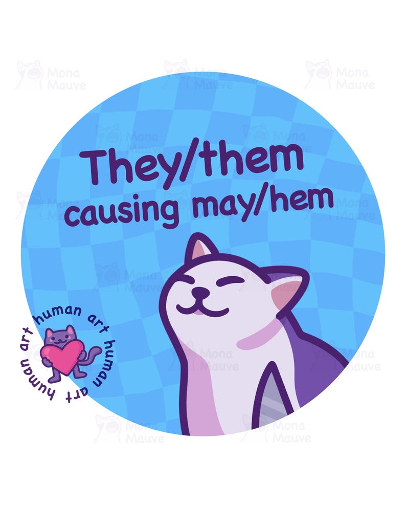 Op de afbeelding: Een ronde blauwe sticker met de tekst "They/them causing may/hem" in paars. Een cartoonkat met paarse en witte vacht staat rechts. Een kleine paarse kat met een roze hart staat links, met de woorden "human art" eromheen.