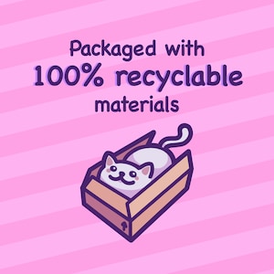 May include: A white cat with a pink nose and black eyes is lying in a brown cardboard box with a white arrow on the side. The box is on a pink and white striped background. The text "Packaged with 100% recyclable materials" is above the box.