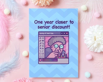 May include: A blue and white birthday card with the text "One year closer to senior discount!" and a cartoon image of a person blowing out candles on a cake. The image is in a computer window with the title "young at heart.jpg".