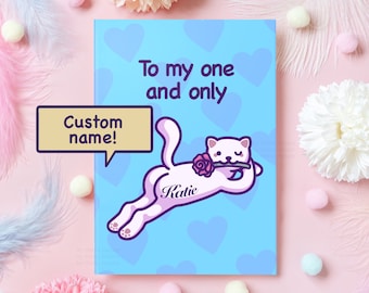 May include: A light blue card with a white cat holding a pink rose. The card says "To my one and only" and has a space for a custom name. The cat has a pink heart on its back with the name "Katie" written on it.