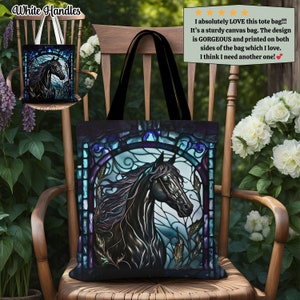 May include: A black canvas tote bag with white handles features a stained glass design of a black horse's head with blue, purple, and gold accents. The tote bag is sitting on a wooden chair.