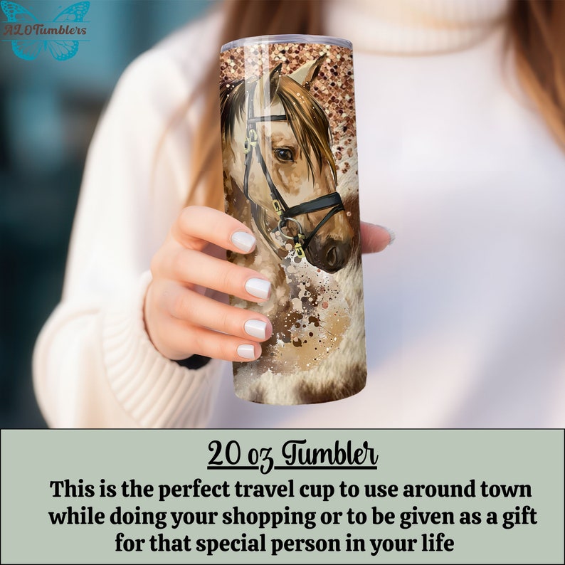 May include: A 20 ounce stainless steel tumbler with a brown and white horse illustration. The horse has a brown bridle and a brown and white mane. The background is a brown and white abstract design.