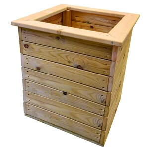 May include: A square wooden planter, constructed from horizontal wooden planks with a natural finish. It features a wide, overhanging top rim. The light-coloured wood has visible knots and grain.