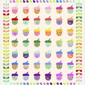 May include: A quilt with a white background and a pattern of colorful acorns. The acorns are arranged in a grid pattern and are surrounded by a border of green leaves.