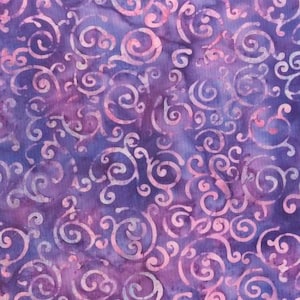 May include: Purple and pink fabric with a swirling pattern. The fabric has a batik style design.